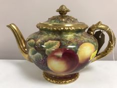 A Royal Worcester gilded teapot decorated with panels of fruit and berries, signed J.