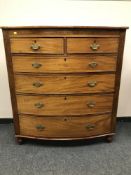 A Victorian inlaid mahogany bow fronted chest of six drawers, width 113 cm.