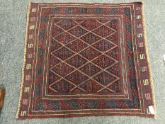 A tribal Gazak rug on red blue ground, 116 cm x 111 cm.