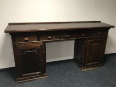 An early 20th century stained pine multi drawer clerk's desk,