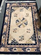 A fringed Chinese rug on cream ground, 123 cm x 183 cm.