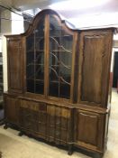 An eighteenth century style continental mahogany break fronted display cabinet on claw and ball