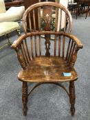 A 19th century elm Windsor child's armchair, height 82 cm.