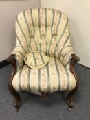 A mid Victorian walnut framed spoon backed armchair, width 69 cm.