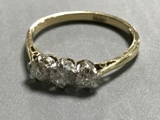 An 18ct gold old cut three stone diamond ring, approximately 0.45ct, size L, 2g.