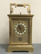 A brass cased quarter-striking and repeating alarm carriage clock,