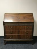 A mid 20th century mahogany bureau, with brass swan neck handles,