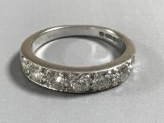 An 18ct white gold diamond half eternity ring, approximately 1ct, size M.
