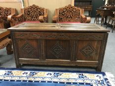 An 18th century oak coffer, with carved frieze, width 126 cm.