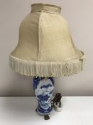 An 18th century Chinese blue and white vase, converted to a table lamp with gilt mounts,