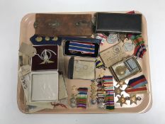 A collection of mid 20th century service medals, military badges, miniature medal groups etc.