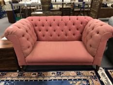 A late Victorian buttoned drop end settee, upholstered in pink fabric, width 157 cm.