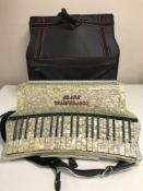 A Stradella Super De Luxe piano accordion with carry case.