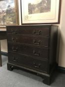 A George III oak chest of four graduated drawers on bracket feet, width 83.5 cm.