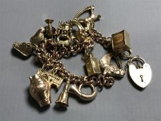 A 9ct gold charm bracelet, 66.8g.