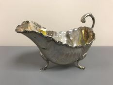 A nineteenth century silver sauce boat, standing on Georgian style shell and hoof feet, 164g.