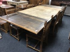 An early 20th century oak extending refectory style dining table, with two leaves,