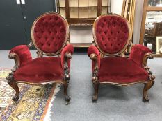 A pair of fine quality Victorian walnut armchairs, upholstered in red velvet, width 72 cm.