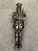 An interesting antique naively carved oak figure depicting a soldier bearing a sword and shield,