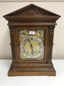 An oak cased quarter-striking table clock,