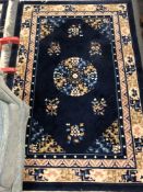 A fringed Chinese rug on blue ground, 182 cm x 122 cm.