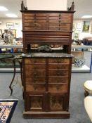 A late Victorian multi drawer horologist's cabinet with shutter front above marble work stand,