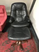 A mid twentieth century Scandinavian black leather relaxer chair with footstool.