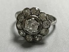 An 18ct white gold old cut diamond cluster ring, the principle stone approximately 0.