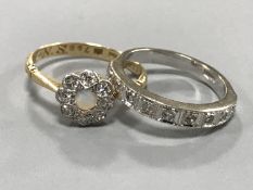 A white gold diamond half eternity ring and an 18ct gold diamond and opal cluster ring