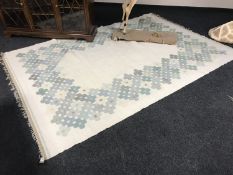 A mid twentieth century wool carpet on cream ground