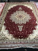 An Isfahan design rug on red ground, 230 cm x 160 cm.