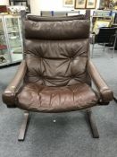 A Scandinavian brown leather lounge chair, height 100 cm.