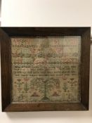 An early 19th century tapestry sampler, dated 1824, 33 cm x 31 cm, in rosewood frame.