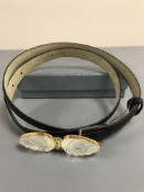 A Lalique black leather dress belt with crystal mounted buckle, in retail box with lining.