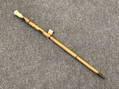 An early 19th century Gentleman's walking cane with ivory pommel, dated 1842.