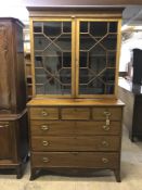 A George III inlaid mahogany bookcase on chest, width 118 cm.