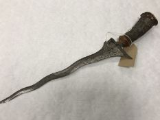 An early 20th century Malayan Kris dagger with Damascus blade.