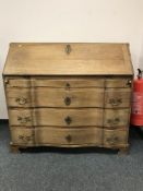 A continental oak serpentine fronted bureau, width 116 cm.