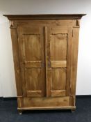 An antique pine double door cabinet,