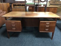 A mid 20th century teak desk fitted with six drawers,