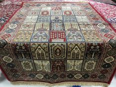 A Ghom design rug on red ground, 170 cm x 120 cm.