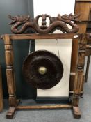 An early 20th century Chinese gong on stand with beater, width 100 cm.