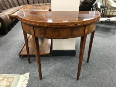 A Regency inlaid walnut d-shaped tea table, width 91 cm.