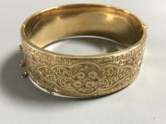 A 9ct gold bangle, 25.8g. CONDITION REPORT: Safety chain broken.