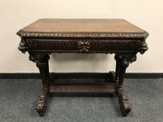 A 19th century carved oak library table fitted with a drawer,