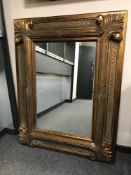 A contemporary overmantel mirror in a substantial gilt frame,