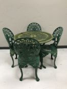 A cast metal garden table and four chairs