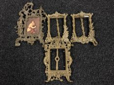 A basket of four ornate gilt photo frames