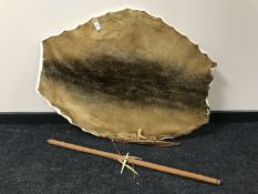A hide mounted on a board,