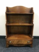 A set of mahogany open shelves fitted a drawer